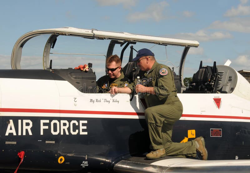 Stuart, USA - November 11, 2011: Instructor and student pilot prepare for flight in the cockpit of a US Air Force training airplane in Stuart, Florida. Stuart, USA - November 11, 2011: Instructor and student pilot prepare for flight in the cockpit of a US Air Force training airplane in Stuart, Florida