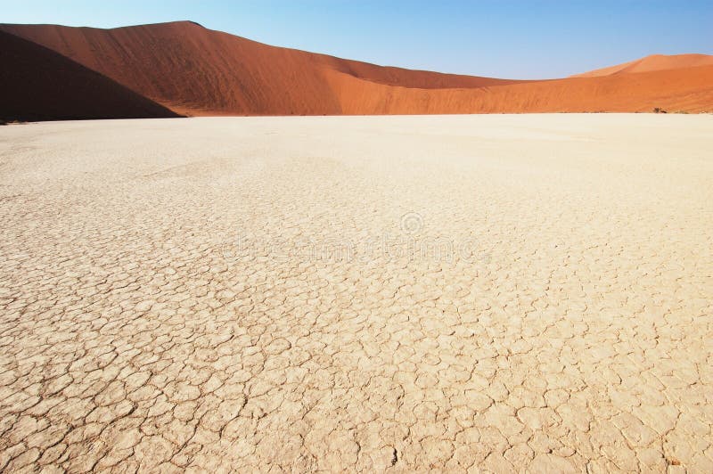 Dry terrain and dune - Lack of water. Namibia, Deadvlei, Sossuvlei. Dry terrain and dune - Lack of water. Namibia, Deadvlei, Sossuvlei.