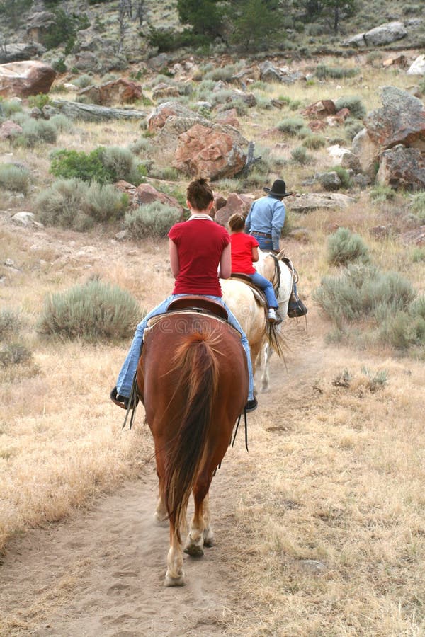 Three people go trail riding in the mountains of Wyoming. Three people go trail riding in the mountains of Wyoming.