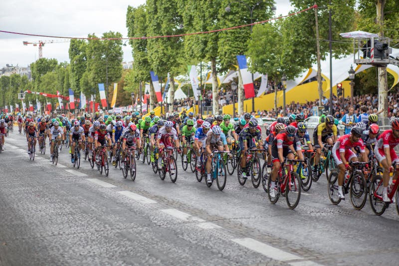 Paris, France - July 23, 2017: Group of cyclists on Avenue des Champs-Elysees for the final stage of the Tour de France 2017. Paris, France - July 23, 2017: Group of cyclists on Avenue des Champs-Elysees for the final stage of the Tour de France 2017