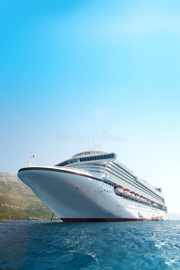 Large modern white cruise ship in the Adriatic sea with the coastline in the background. Large modern white cruise ship in the Adriatic sea with the coastline in the background.