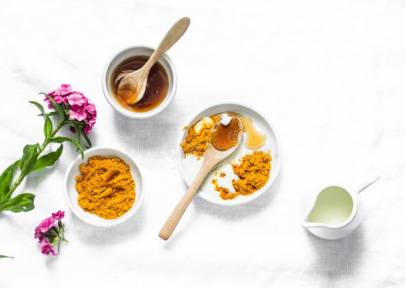 Turmeric, honey, coconut milk face mask. Homemade ingredients beauty products on a light background, top view. Beauty, skin care concept. Turmeric, honey, coconut milk face mask. Homemade ingredients beauty products on a light background, top view. Beauty, skin care concept