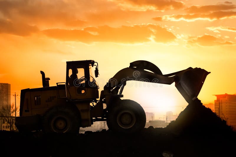 Heavy wheel excavator machine working at sunset. Heavy wheel excavator machine working at sunset