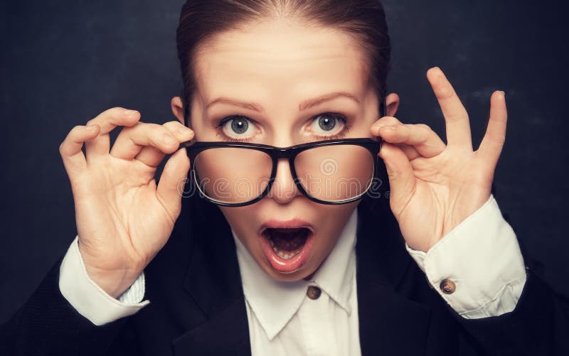 Surprised funny teacher in glasses shouts at the school board. Surprised funny teacher in glasses shouts at the school board