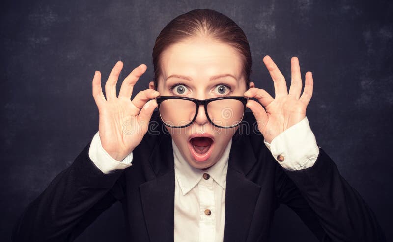 Surprised funny teacher in glasses shouts at the school board. Surprised funny teacher in glasses shouts at the school board