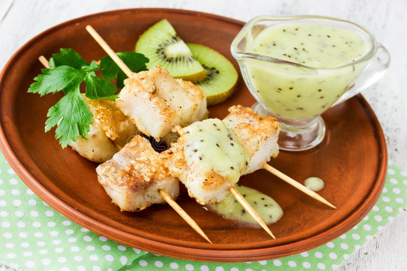 Удите kebabs на бамбуковых протыкальниках с светлым соусом кивиа стоковые фото Удите kebabs на бамбуковых протыкальниках с светлым соусом кивиа стоковые фото