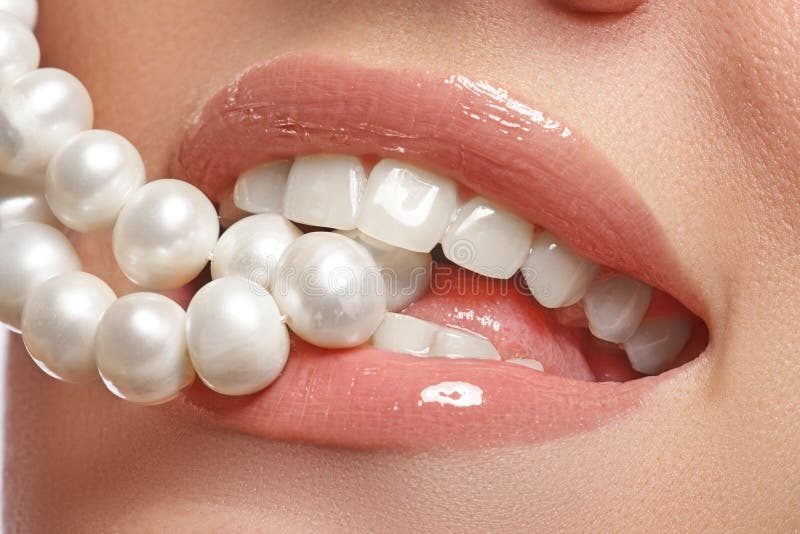 Close-up happy female smile with healthy white teeth, bright red lips make-up. Cosmetology, dentistry and beauty care. Macro of woman's smiling mouth. Close-up happy female smile with healthy white teeth, bright red lips make-up. Cosmetology, dentistry and beauty care. Macro of woman's smiling mouth