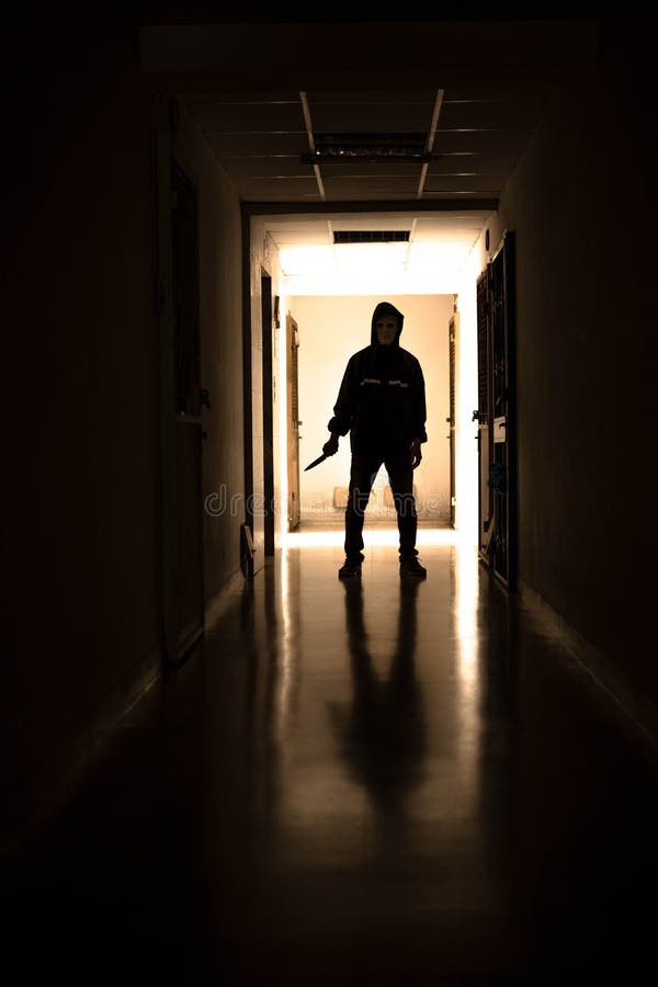 Murder wear the mask holding a knife and Standing in the old apartment, kill and people concept - Criminal or murderer with blood on knife at crime scene. Murder wear the mask holding a knife and Standing in the old apartment, kill and people concept - Criminal or murderer with blood on knife at crime scene.