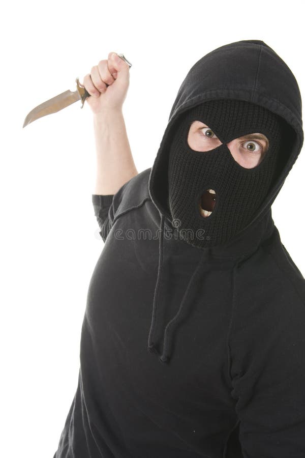 Evil criminal wearing balaclava with a knife. Evil criminal wearing balaclava with a knife