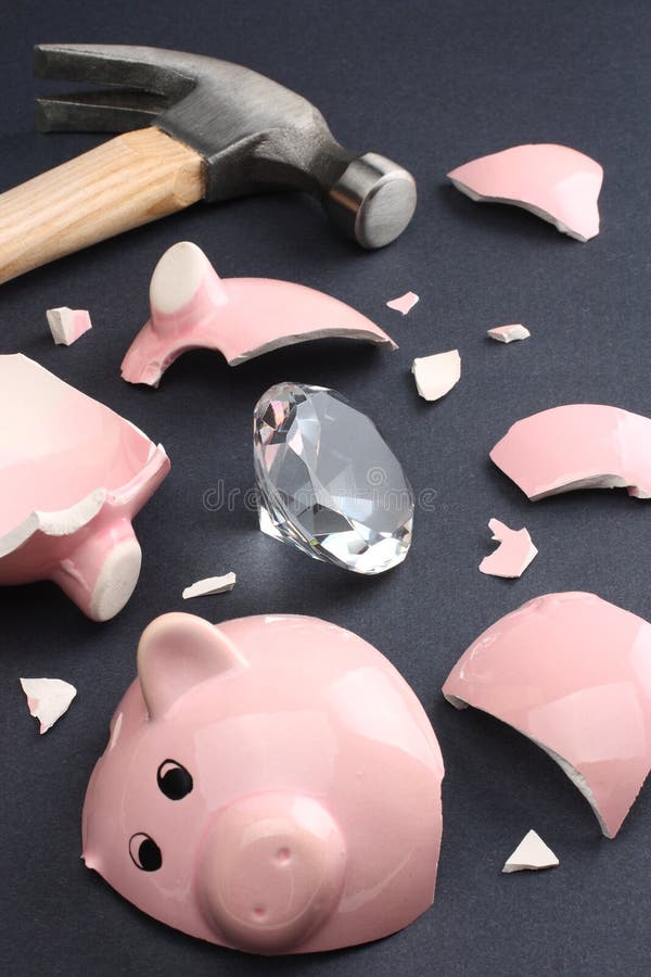 Broken piggy bank containing a diamond conveying a sense of luck, fortune and wealth. Business & Finance Collection. Broken piggy bank containing a diamond conveying a sense of luck, fortune and wealth. Business & Finance Collection.