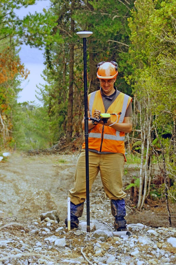 Man surveying the location of geophones for a seismic reflective survey on the West Coast of New Zealand. Man surveying the location of geophones for a seismic reflective survey on the West Coast of New Zealand