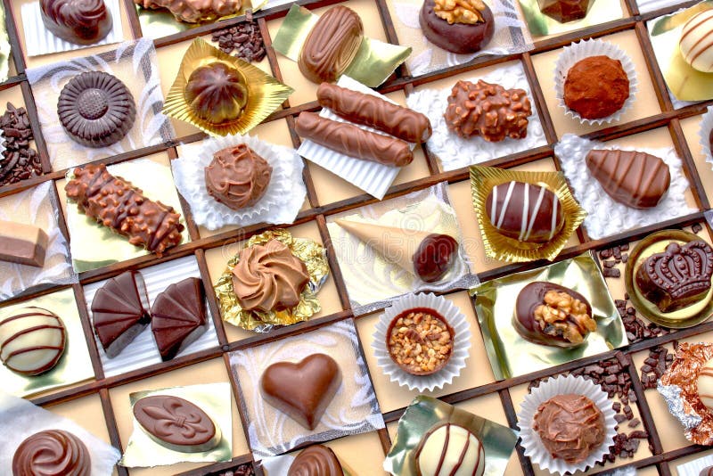 A collage of decorated fancy chocolates on a grid pattern. A collage of decorated fancy chocolates on a grid pattern.