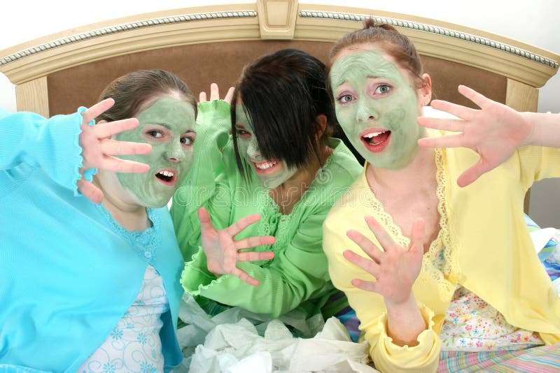 Three teen girls caught doing facial mask at home. Fourteen year old girls with hair back and green mask on face trying to hide from camera. Three teen girls caught doing facial mask at home. Fourteen year old girls with hair back and green mask on face trying to hide from camera.