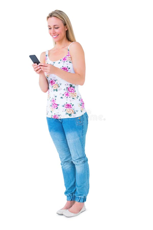 Smiling blonde sending a text message on white background. Smiling blonde sending a text message on white background