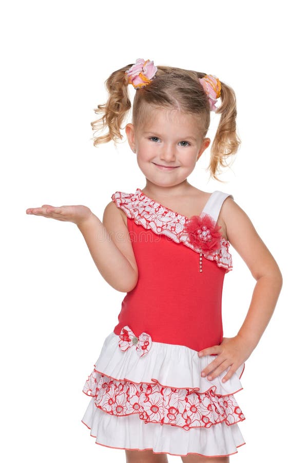 A smiling little girl makes a hand gesture against the white background. A smiling little girl makes a hand gesture against the white background