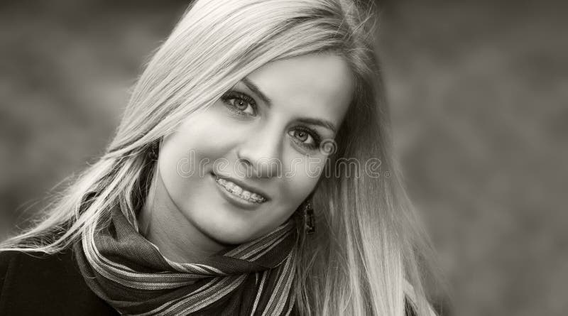 Black and white portrait of a young smiling blond girl with braces. Black and white portrait of a young smiling blond girl with braces