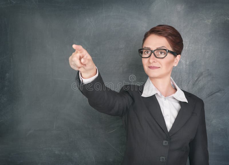 Smiling teacher pointing on someone. Smiling teacher pointing on someone