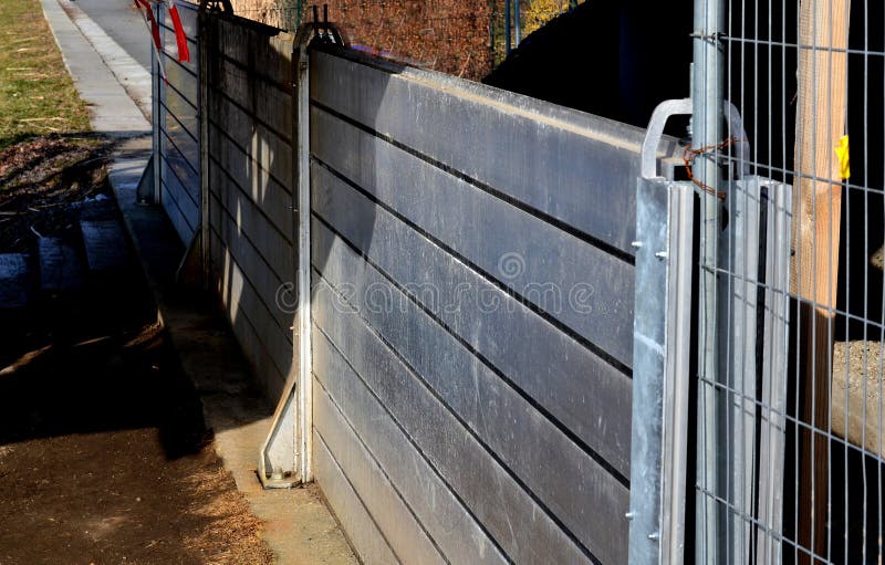 installation of portable anti-flood fences. the gate protects the city during a flood. if the river level rises, firefighters will build a portable dike, wall. it is screwed on and sealed rubber. installation of portable anti-flood fences. the gate protects the city during a flood. if the river level rises, firefighters will build a portable dike, wall. it is screwed on and sealed rubber