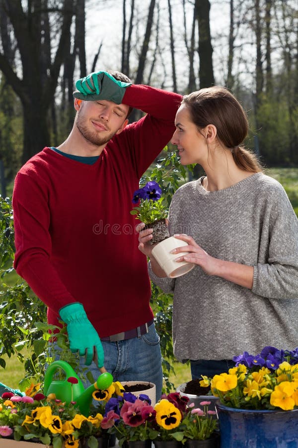 Tired couple during working in the garden, vertical. Tired couple during working in the garden, vertical