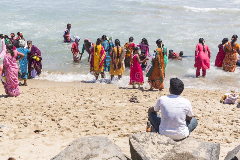 MASI MAGAM FESTIVAL, PUDUCHERY, PONDICHERY, TAMIL NADU, INDIA - March 1, 2018. Group of unidentified Indian pilgrims women men bathing in the sea, on the beach. MASI MAGAM FESTIVAL, PUDUCHERY, PONDICHERY, TAMIL NADU, INDIA - March 1, 2018. Group of unidentified Indian pilgrims women men bathing in the sea, on the beach