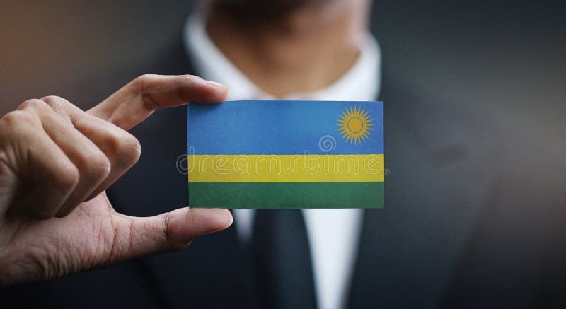 Флаг Руанды карты удерживания бизнесмена стоковые фото