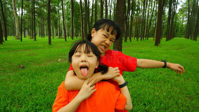 Background image of 2 happy girls playing relaxing in a holiday park. Background image of 2 happy girls playing relaxing in a holiday park