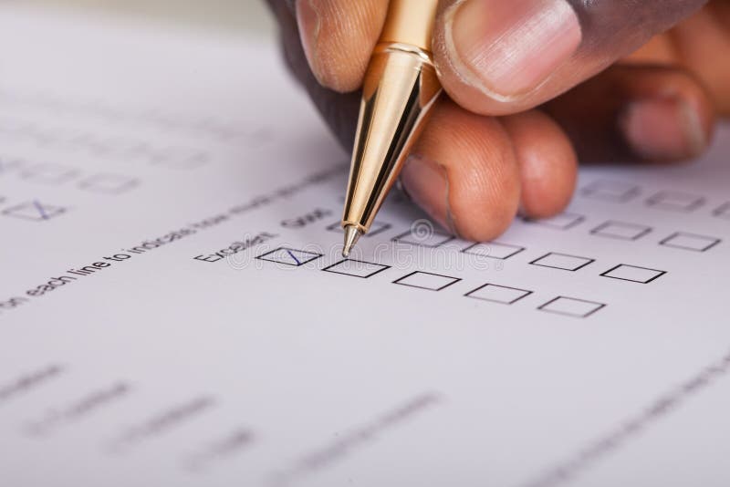 Close-up Of Businessman Filling Customer Survey Form. Close-up Of Businessman Filling Customer Survey Form