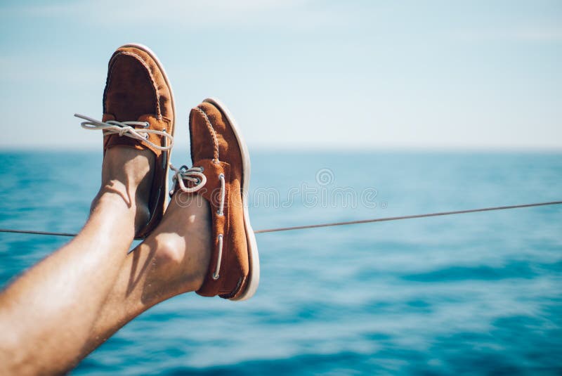 Photo of man legs on the yacht and wearing boat shoes. Horizontal mockup. Photo of man legs on the yacht and wearing boat shoes. Horizontal mockup