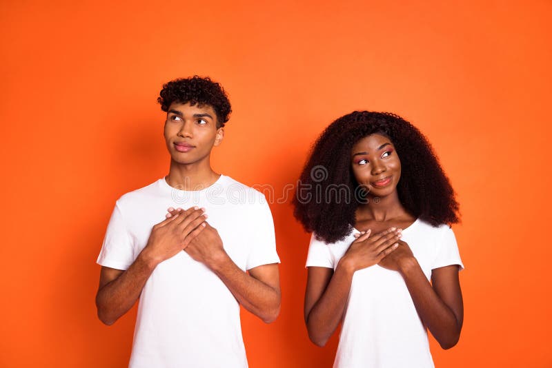 Photo of young happy positive smiling dreamy thankful afro couple look copyspace isolated on orange color background. Photo of young happy positive smiling dreamy thankful afro couple look copyspace isolated on orange color background.