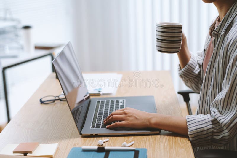 Freelancer drinking morning coffee and checking e-mails from client on laptop. Freelancer drinking morning coffee and checking e-mails from client on laptop