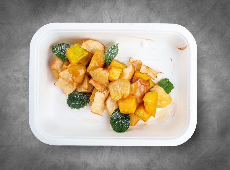 Fruit salad with mint. Healthy diet. Takeaway food. Top view, on a gray background. Fruit salad with mint. Healthy diet. Takeaway food. Top view, on a gray background.