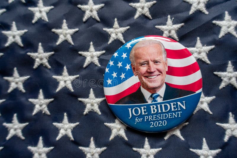 Harrisburg, PA - October 2, 2019 - Joe Biden campaign button against a United States of America flag. Selective focus and depth of field. Harrisburg, PA - October 2, 2019 - Joe Biden campaign button against a United States of America flag. Selective focus and depth of field