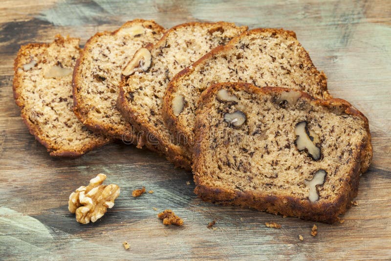 Slices of fresh banana bread with walnut on a cutting board. Slices of fresh banana bread with walnut on a cutting board