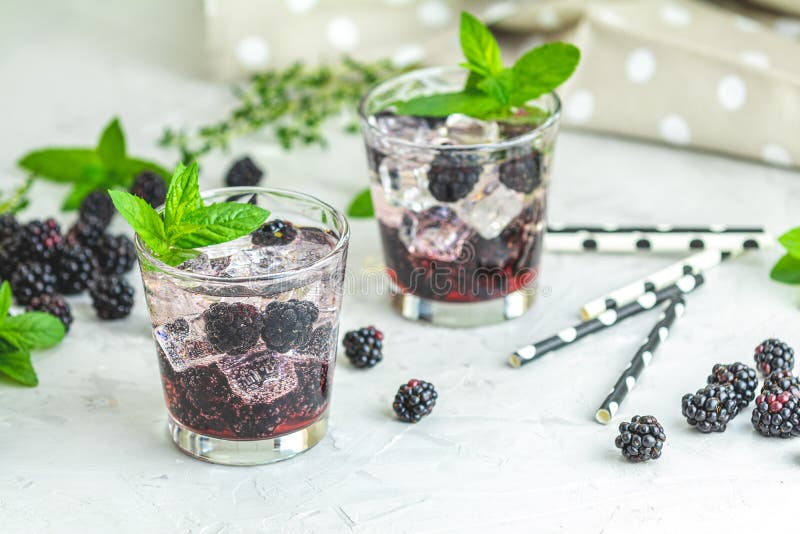 Cold summer berry drink with blackberries. Refreshing summer drink with syrup, blackberry and ice on light gray concrete background, lemonade, blueberry, cocktail, mojito, bourbon, dark, purple, sangria, glass, healthy, lime, eating, gin, smash, wood, abuse, alcohol, close-up, color, cool, cube, culinary, food, freshness, frozen, fruit, homemade, juice, leaf, martini, mint, punch, red, refreshment, rustic, soda, sweet, temperature, tonic, water, wooden. Cold summer berry drink with blackberries. Refreshing summer drink with syrup, blackberry and ice on light gray concrete background, lemonade, blueberry, cocktail, mojito, bourbon, dark, purple, sangria, glass, healthy, lime, eating, gin, smash, wood, abuse, alcohol, close-up, color, cool, cube, culinary, food, freshness, frozen, fruit, homemade, juice, leaf, martini, mint, punch, red, refreshment, rustic, soda, sweet, temperature, tonic, water, wooden