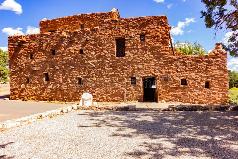 The building which resembles a historic Native American structure was designed and constructed in 1904 by Mary Colter at the South Rim of the Grand Canyon as a place to purchase Native American crafts that were fashioned by local artists. The outside resembles a traditional Hopi pueblo.  The material used for the outside is sandstone of different sizes giving it a step pattern.  The roof is flat and serves as walkways as it does in other Hopi buildings.  All the windows and doorways are meager in size. Inside, the walls are adobe; the ceilings are twigs, grass and covered with mud.  The staircase is adorned with paintings by an anonymous Hopi artist.  The floors look adobe but are cement but were later covered in hard wood. The building which resembles a historic Native American structure was designed and constructed in 1904 by Mary Colter at the South Rim of the Grand Canyon as a place to purchase Native American crafts that were fashioned by local artists. The outside resembles a traditional Hopi pueblo.  The material used for the outside is sandstone of different sizes giving it a step pattern.  The roof is flat and serves as walkways as it does in other Hopi buildings.  All the windows and doorways are meager in size. Inside, the walls are adobe; the ceilings are twigs, grass and covered with mud.  The staircase is adorned with paintings by an anonymous Hopi artist.  The floors look adobe but are cement but were later covered in hard wood.