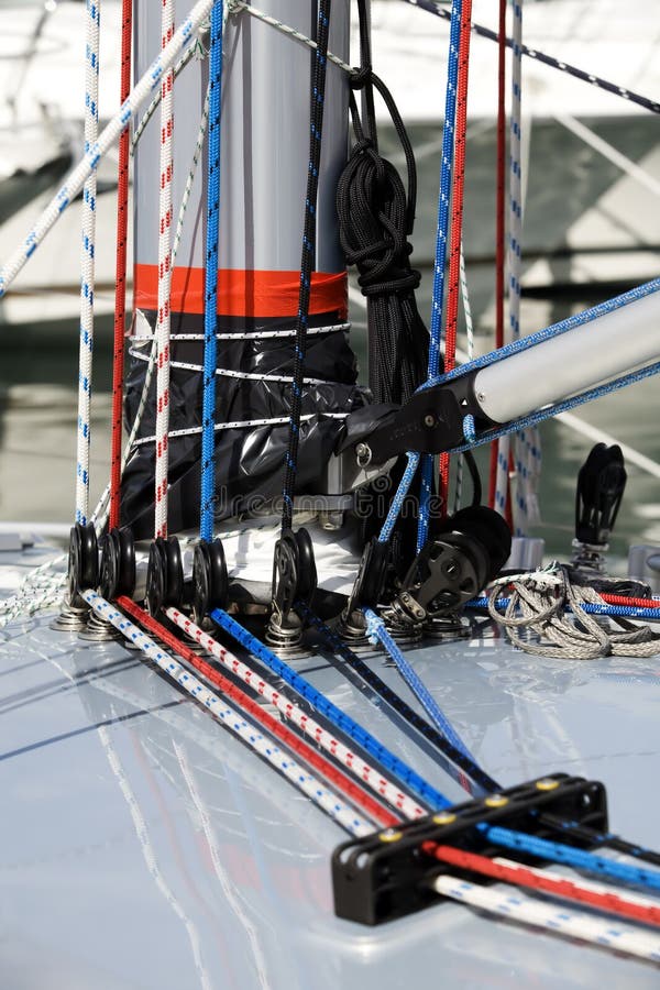 Close up of ropes and equipment on the side of a mast on a new yacht. Close up of ropes and equipment on the side of a mast on a new yacht.