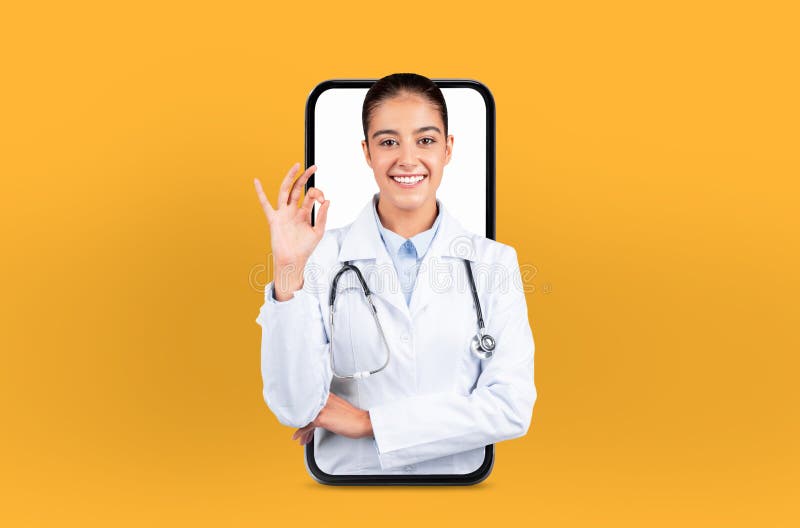 Depicting digital health technology, a young woman stands as a doctor within a smartphone, embodying the future of telehealth, showing okay gesture. Depicting digital health technology, a young woman stands as a doctor within a smartphone, embodying the future of telehealth, showing okay gesture