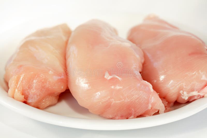 Raw chicken breast on white plate. Raw chicken breast on white plate