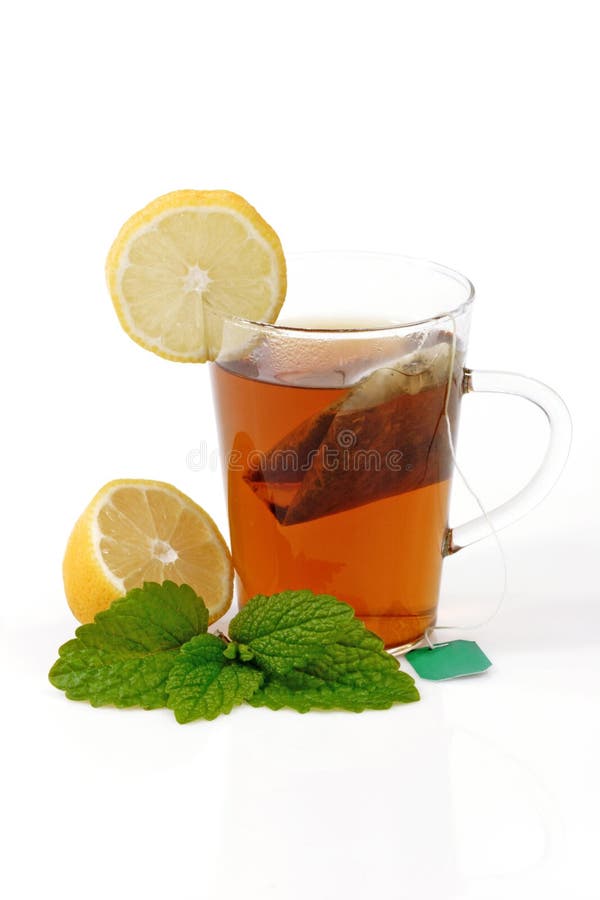 Peppermint tea in a glass on bright background. Peppermint tea in a glass on bright background