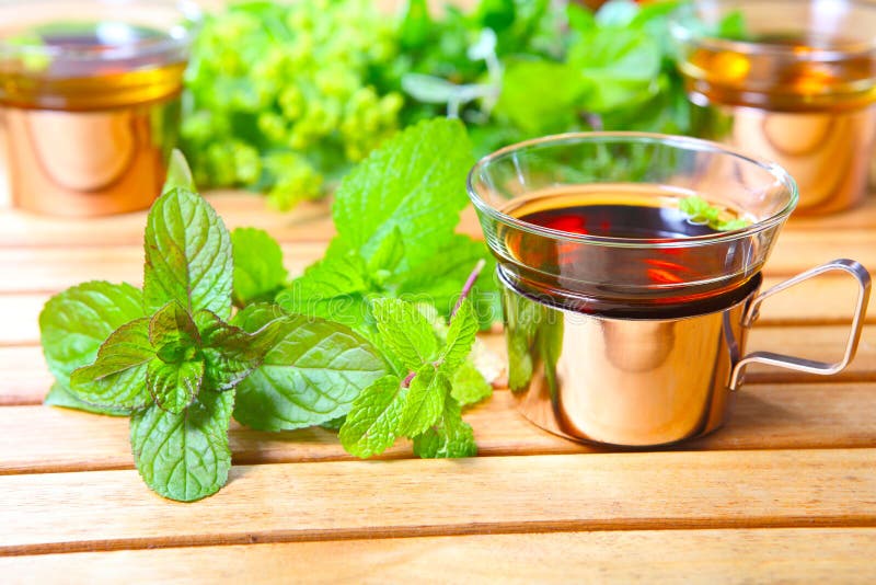 Peppermint tea, medicinal herbs on the garden table. Peppermint tea, medicinal herbs on the garden table