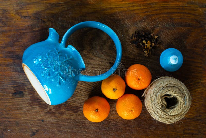 tea, tangerines, nuts and spices on a wooden table. Winter breakfast. tea, tangerines, nuts and spices on a wooden table. Winter breakfast.