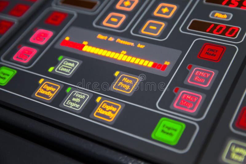 Fragment of illuminated ship control panel on the captain bridge in the dark. Selective focus, shallow DOF. Fragment of illuminated ship control panel on the captain bridge in the dark. Selective focus, shallow DOF