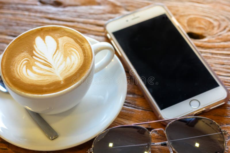 Чашка кофе искусства latte с ложкой и плитой на предпосылке текстуры коричневой расшивы красивой стоковое фото rf Чашка кофе искусства latte с ложкой и плитой на предпосылке текстуры коричневой расшивы красивой стоковое фото rf