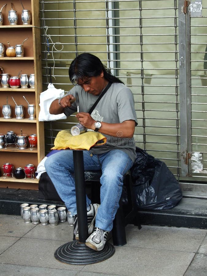 The unknown man makes cups for mate on the city streets on October 2009 in Buenos Aires, Argentina. The unknown man makes cups for mate on the city streets on October 2009 in Buenos Aires, Argentina.