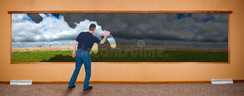 A man washes a dirty window while at home doing spring cleaning. Image is in the format of a banner, panoramic, or panorama. A man washes a dirty window while at home doing spring cleaning. Image is in the format of a banner, panoramic, or panorama.