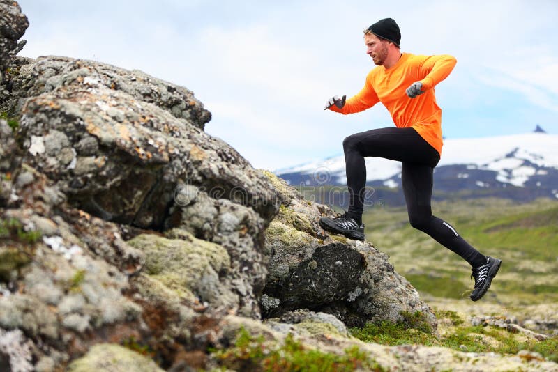 Sport running man in cross country trail run. Fit male runner exercise training and jumping outdoors in beautiful mountain nature landscape with Snaefellsjokull, Snaefellsnes, Iceland. Sport running man in cross country trail run. Fit male runner exercise training and jumping outdoors in beautiful mountain nature landscape with Snaefellsjokull, Snaefellsnes, Iceland.
