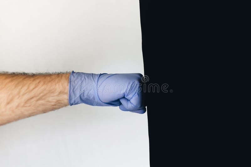 Man hits punching bag with medical gloves with a white background. Man hits punching bag with medical gloves with a white background.