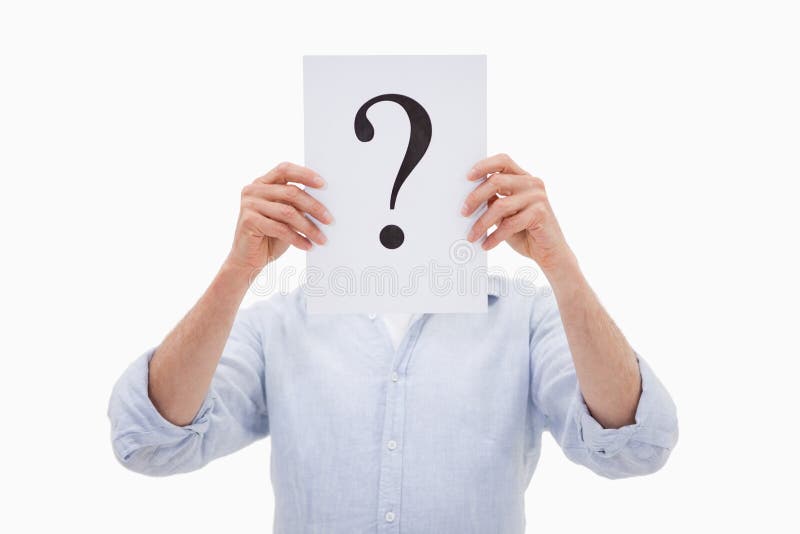 Portrait of a man hiding his face behind a question mark against a white background. Portrait of a man hiding his face behind a question mark against a white background