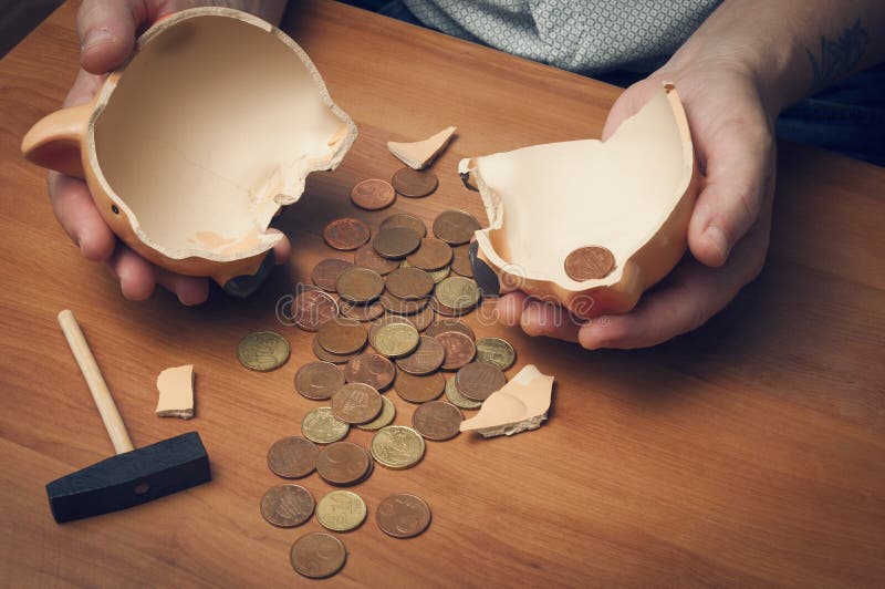 Man counting savings from a broken piggybank. Man counting savings from a broken piggybank.