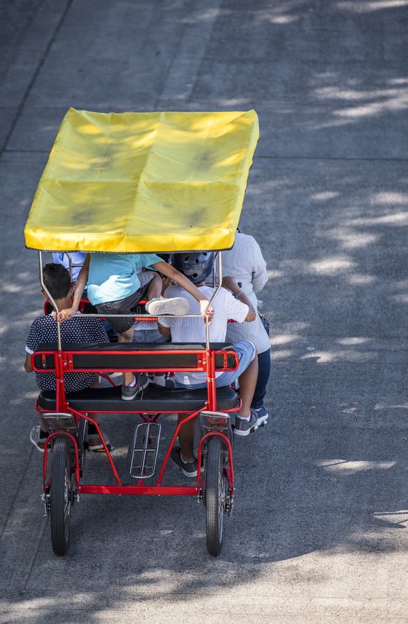 Four-wheeled bike filled with cyclists of different ages. The use of a bicycle as the main transport for many enthusiasts has grown from a hobby into vital necessity. Four-wheeled bike filled with cyclists of different ages. The use of a bicycle as the main transport for many enthusiasts has grown from a hobby into vital necessity.